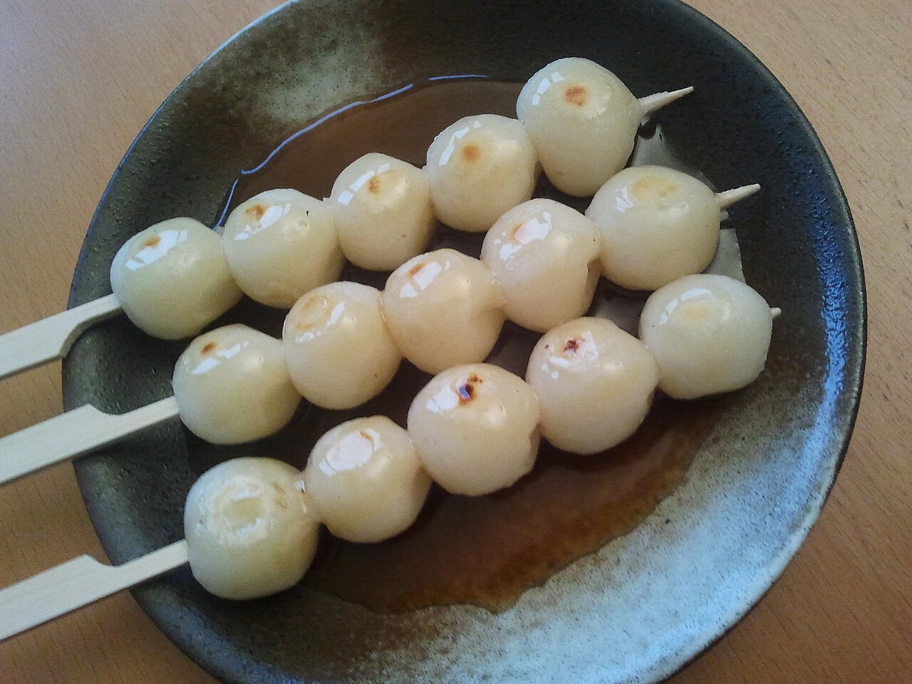 Mitarashi dango skewers served on a plate