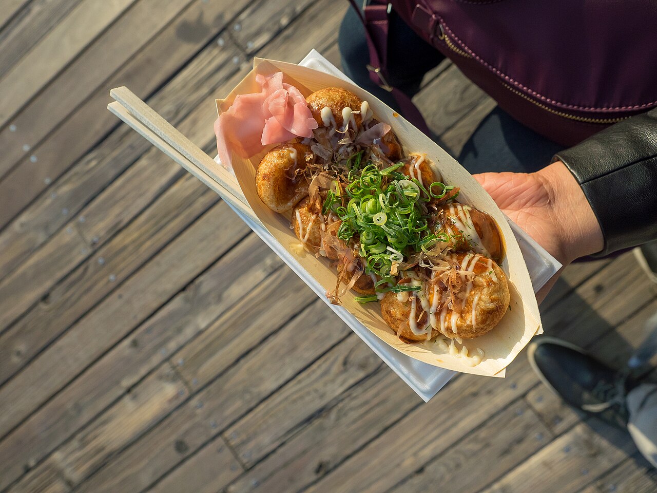 Japanese street food: takoyaki with sauce and bonito flakes in Osaka